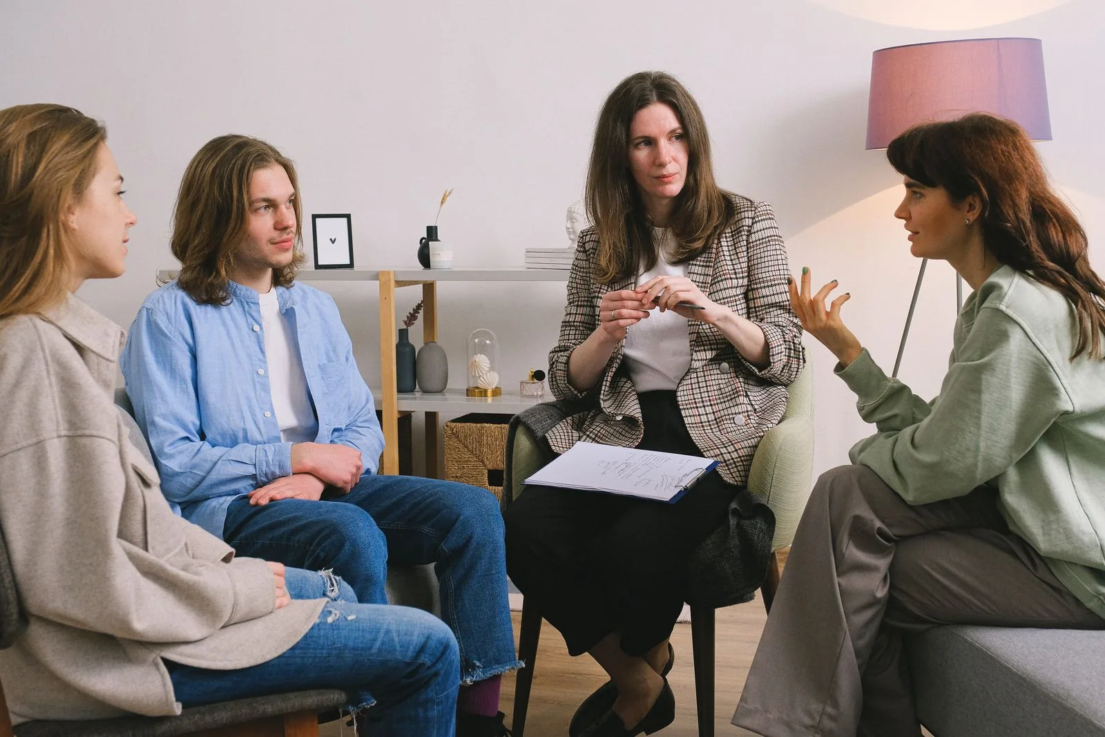 Adults seated in a group conversation